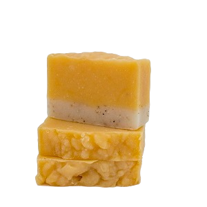Stack of Moxxie handcrafted botanical bar soap in citrus blend, showing their creamy orange and tan texture