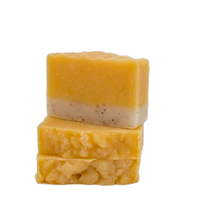 Stack of Moxxie handcrafted botanical bar soap in citrus blend, showing their creamy orange and tan texture