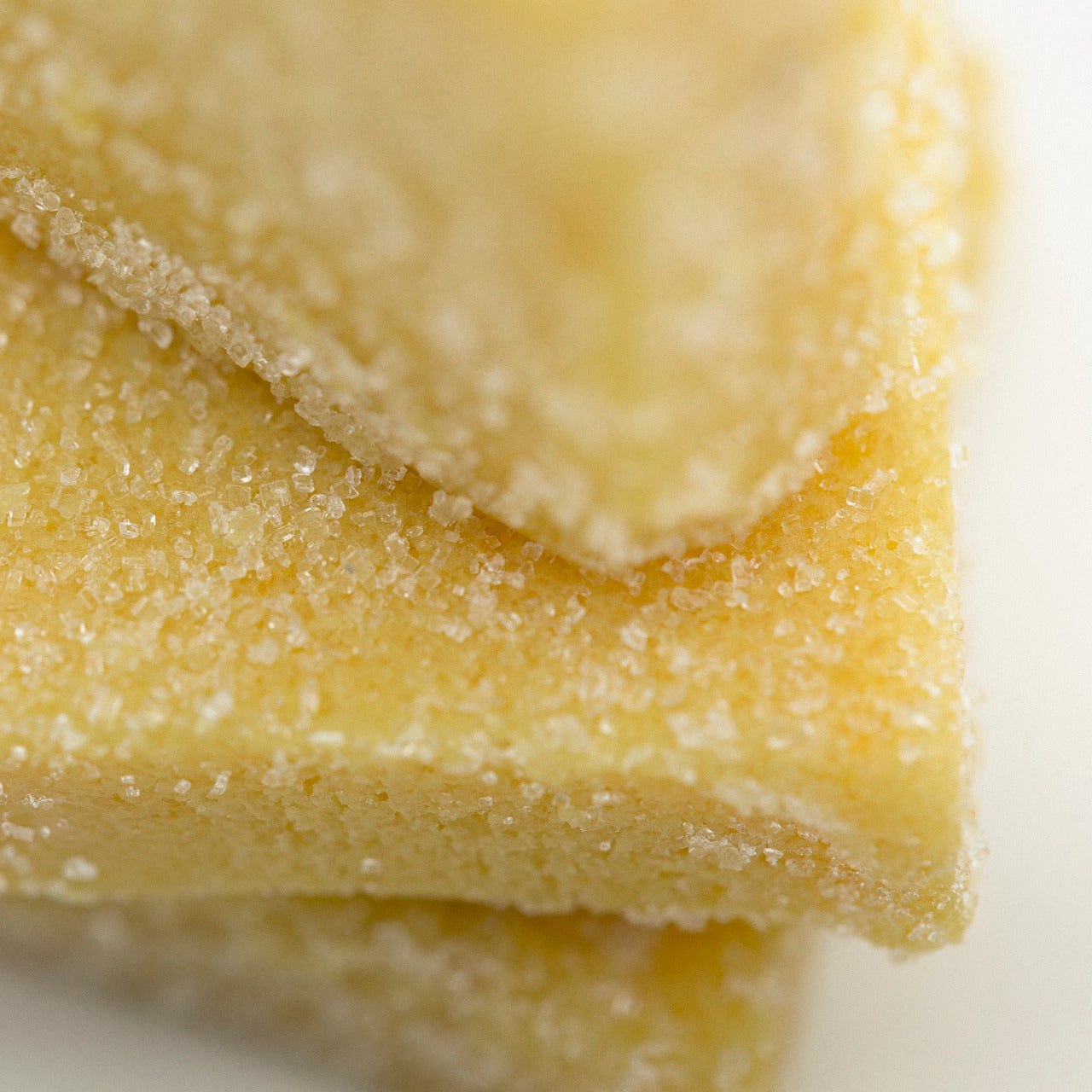 Close up of Citrus sugar scrub showing it's delicate orange color and sugary texture