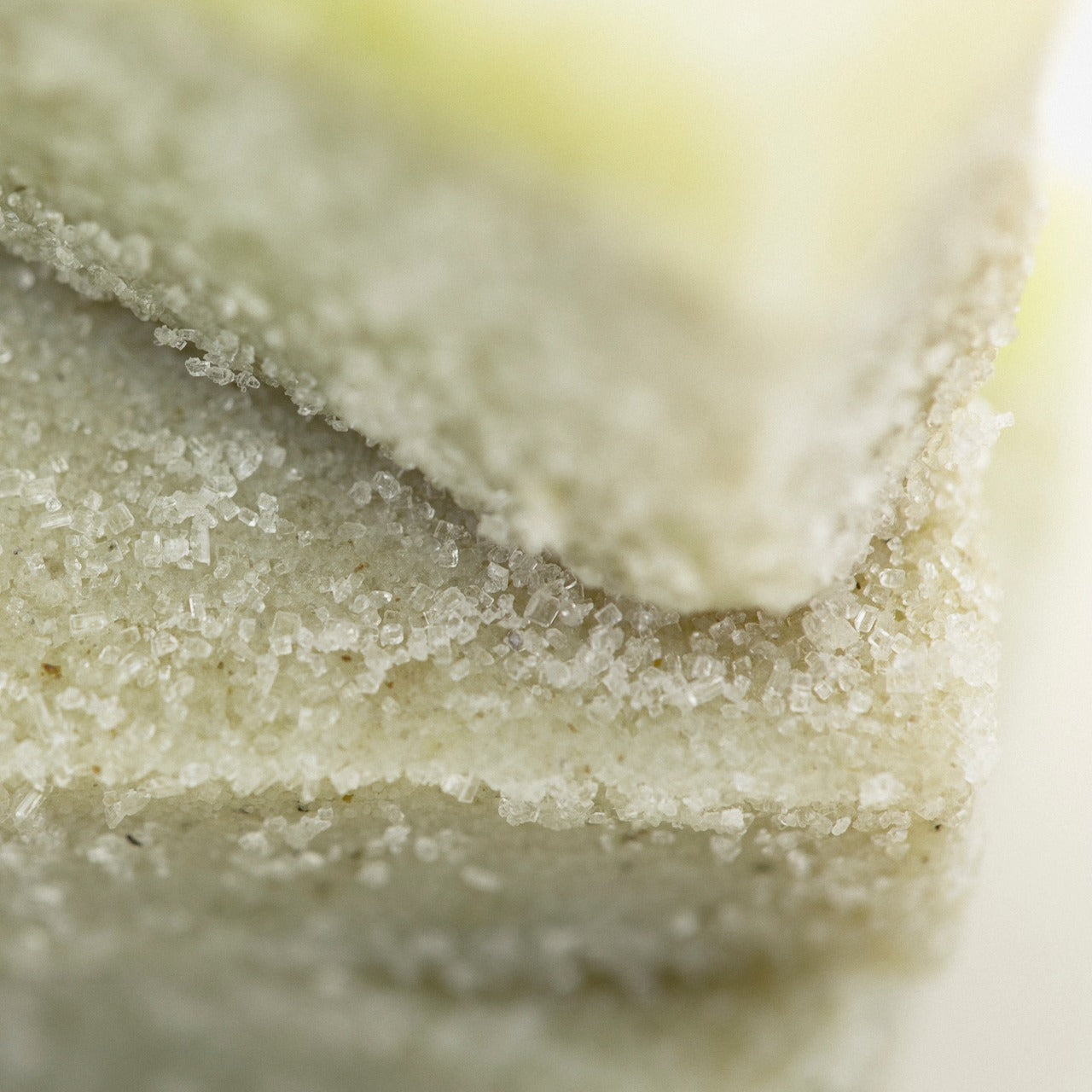 Close up of Eucalyptus sugar scrub cube showing it's delicate olive green color and sugary texture