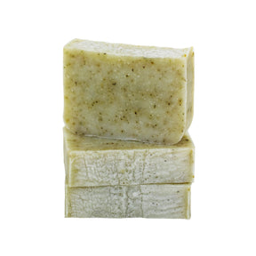 A stack of Moxxie's peppermint and tea tree bar soap, showing it's creamy olive green color with speckles of crushed peppermint leaves